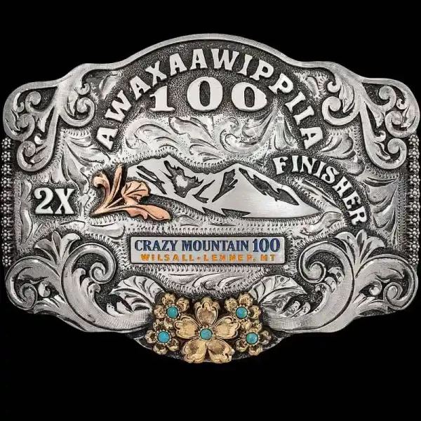 "Our Wilsall Belt Buckle is crafted on a German Silver base featuring our signature western-inspired scrollwork, lettering, berry edge, and antique finish. We have added a stunning floral piece with your choice of cubic zirconia stones in Jeweler's B